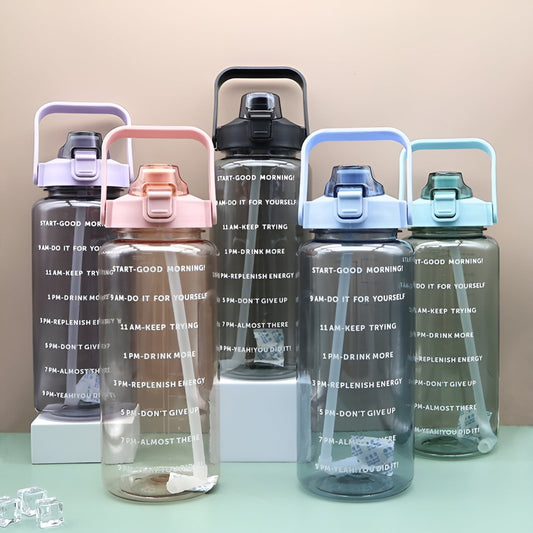 Set of motivational water bottles with different colored lids on a light green surface.