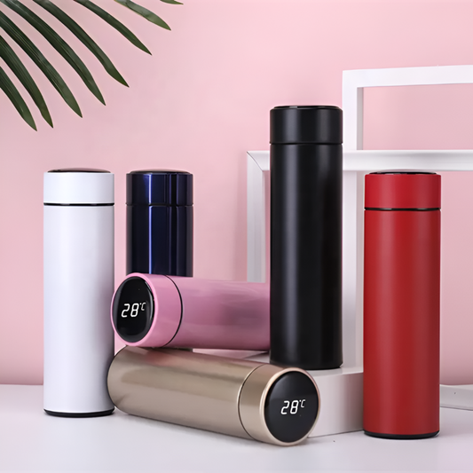Set of colorful thermos bottles with digital temperature displays on a pink background